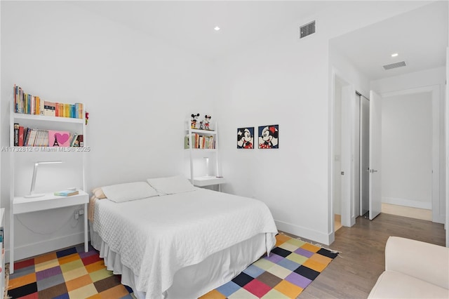 bedroom with hardwood / wood-style floors