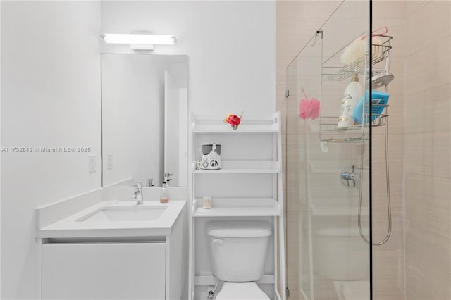 bathroom featuring vanity, a shower with shower door, and toilet