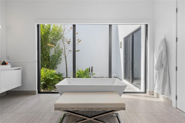 bathroom with sink and a tub to relax in