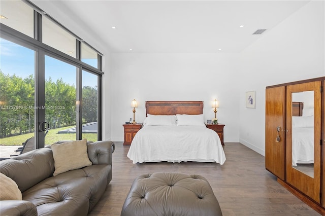 bedroom featuring access to exterior and hardwood / wood-style flooring