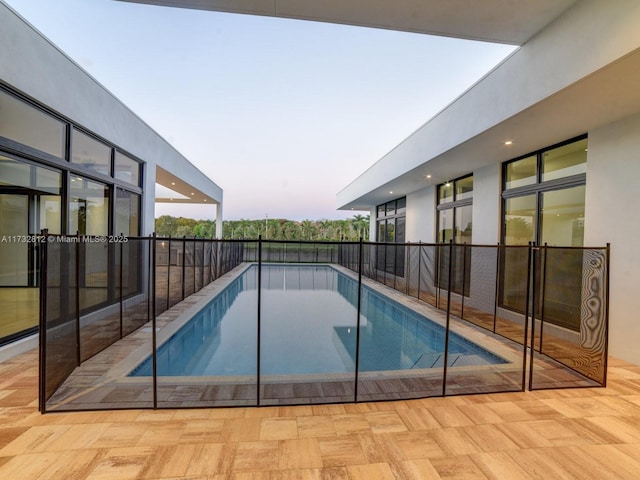 view of pool at dusk