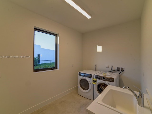 washroom featuring separate washer and dryer and sink