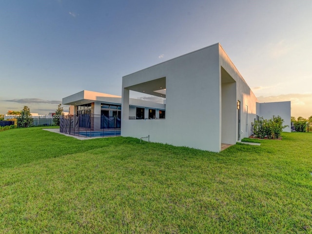 back house at dusk with a yard