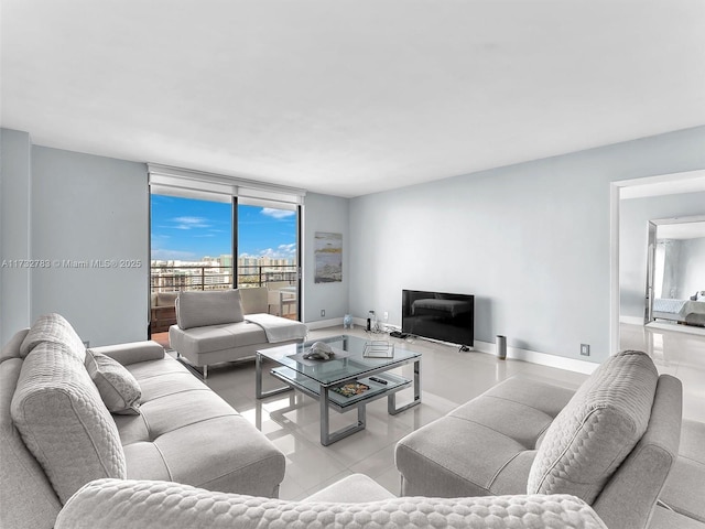 living room with floor to ceiling windows and light tile patterned floors