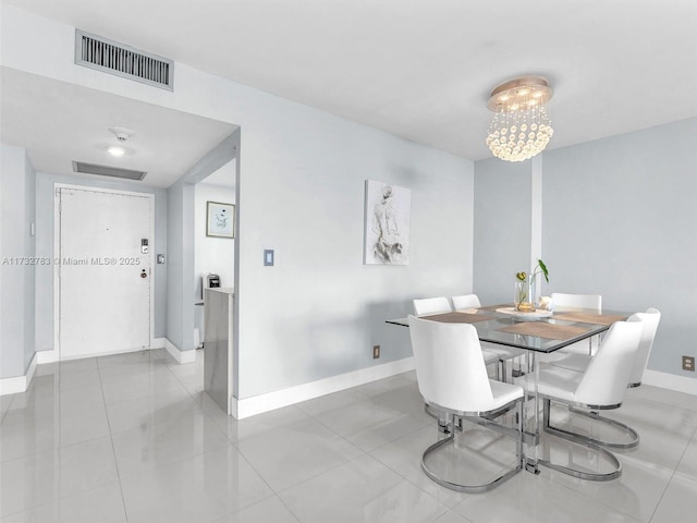 dining space featuring an inviting chandelier and light tile patterned floors