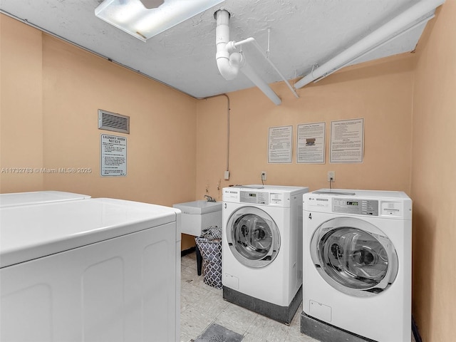 clothes washing area featuring washing machine and clothes dryer