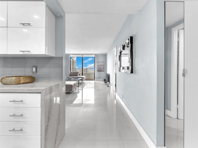 hall featuring light tile patterned flooring