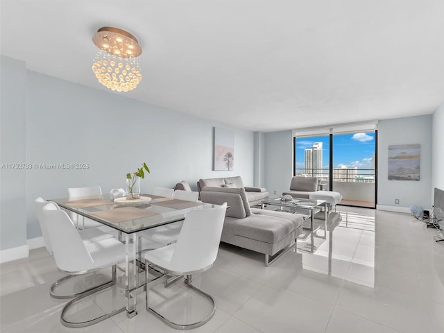 dining room with light tile patterned floors, floor to ceiling windows, and a chandelier