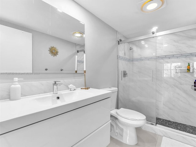 bathroom with vanity, tile patterned flooring, a shower with door, and toilet