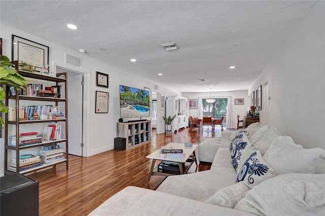 living room featuring hardwood / wood-style flooring and a textured ceiling