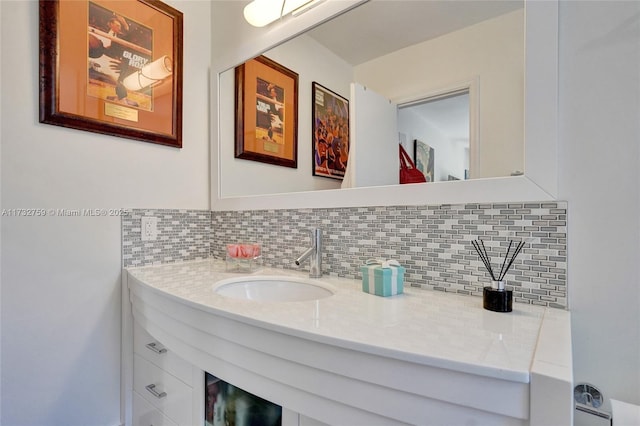 bathroom featuring tasteful backsplash and sink