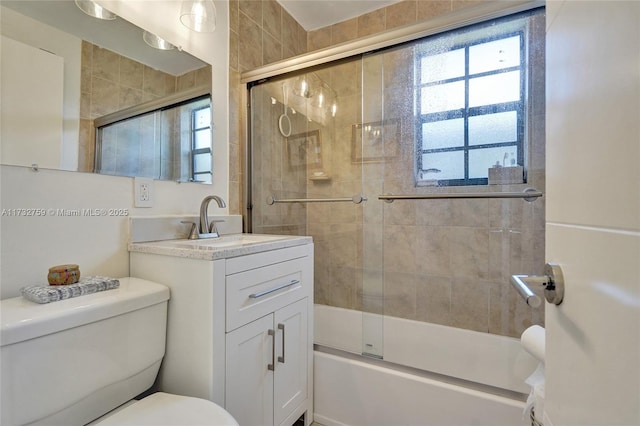 full bathroom featuring vanity, toilet, and combined bath / shower with glass door