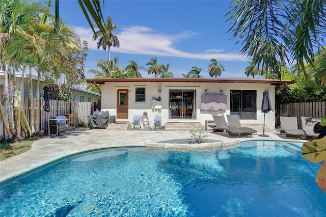 view of swimming pool with area for grilling and a patio area