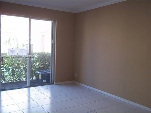 spare room featuring light tile patterned floors