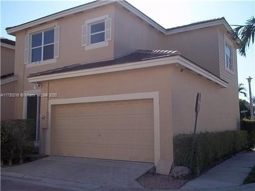 view of side of home featuring a garage