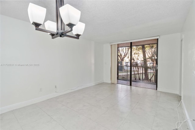 empty room with floor to ceiling windows, a chandelier, and a textured ceiling