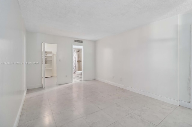 empty room featuring a textured ceiling