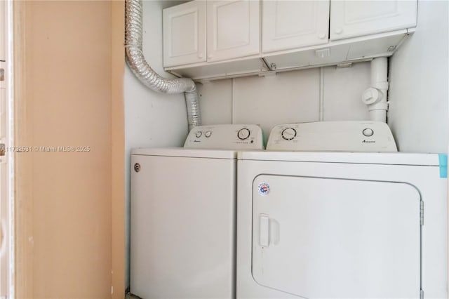 laundry area featuring independent washer and dryer and cabinets