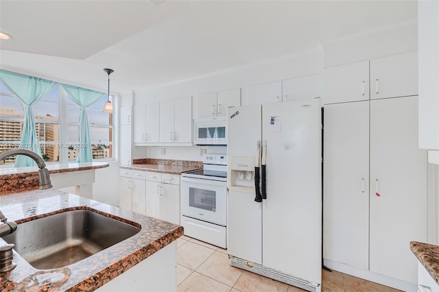 kitchen featuring light tile patterned flooring, decorative light fixtures, sink, white cabinets, and white appliances