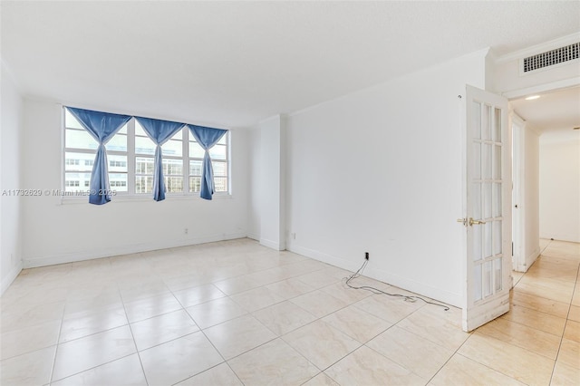 unfurnished room featuring light tile patterned flooring