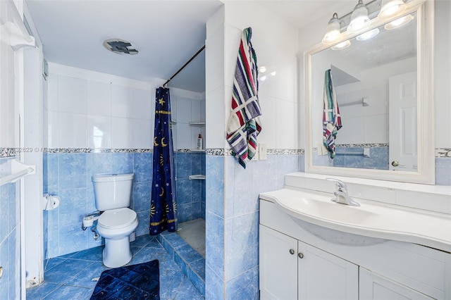 bathroom featuring tile walls, vanity, curtained shower, and toilet