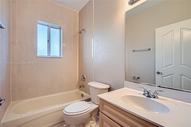 full bathroom with vanity, toilet, and tiled shower / bath