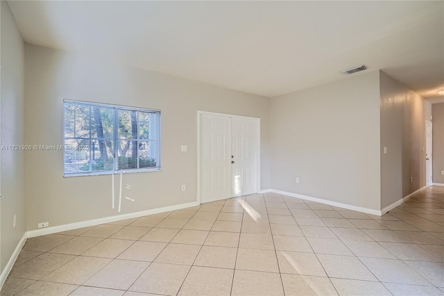 spare room featuring light tile patterned floors