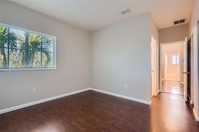 unfurnished room featuring dark hardwood / wood-style flooring