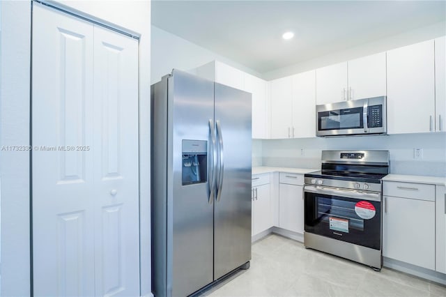 kitchen with appliances with stainless steel finishes and white cabinets