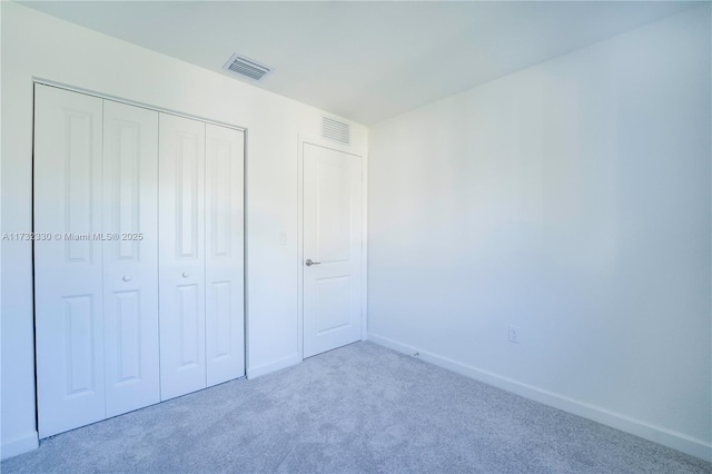 unfurnished bedroom featuring a closet and carpet