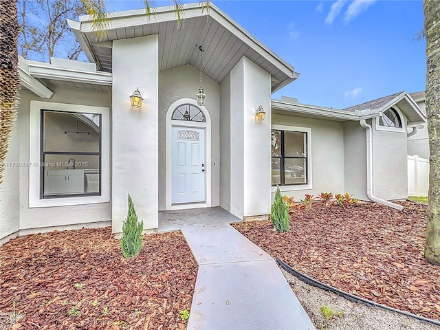 entrance to property with stucco siding