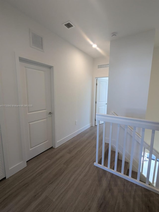 hallway with dark hardwood / wood-style flooring