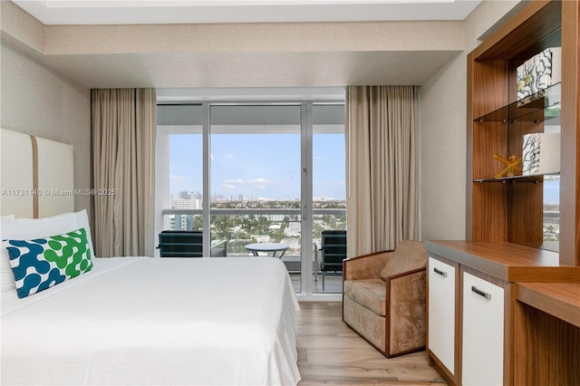 bedroom featuring access to exterior and light hardwood / wood-style floors