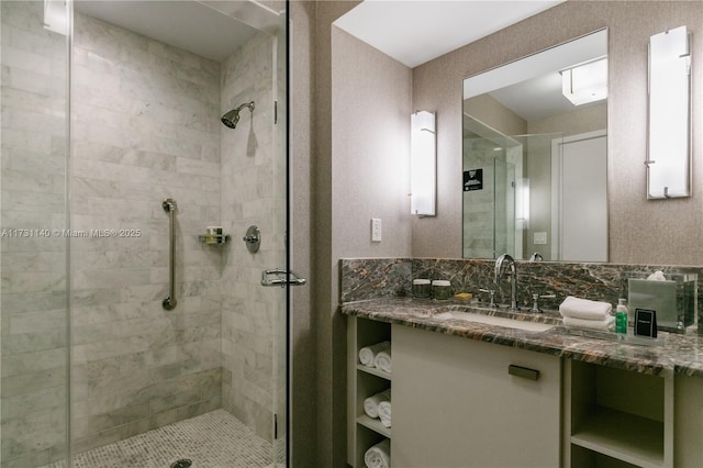 bathroom with tasteful backsplash, vanity, and walk in shower