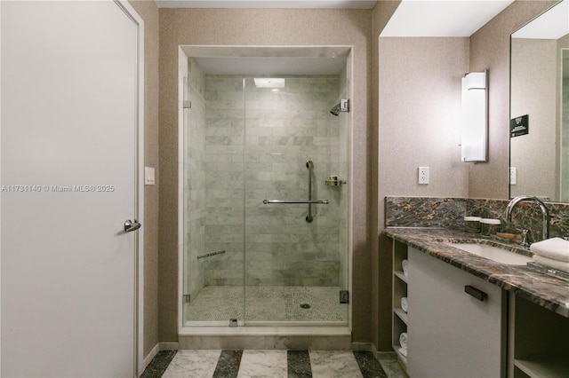 bathroom with vanity and a shower with door