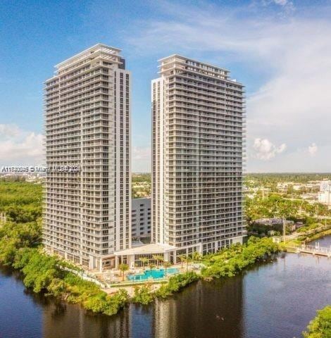 view of property with a view of city and a water view