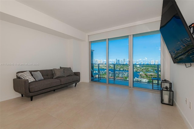 living area with floor to ceiling windows and baseboards