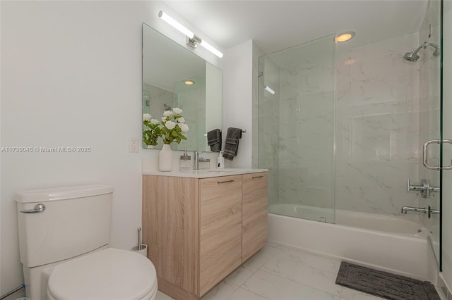 full bath with shower / bath combination, marble finish floor, toilet, and vanity