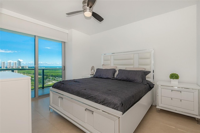 bedroom featuring a ceiling fan, access to outside, and a city view