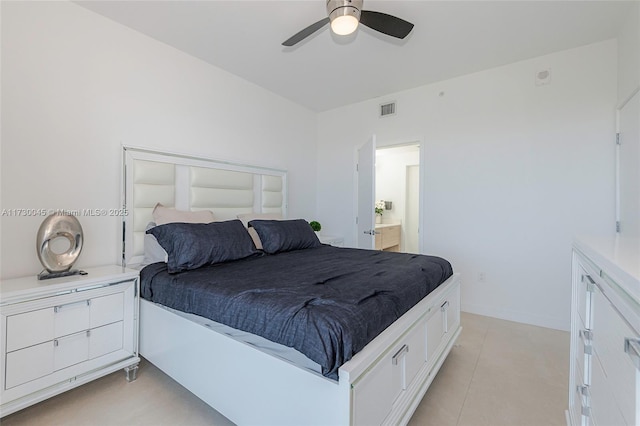 bedroom featuring visible vents, ensuite bathroom, light tile patterned flooring, ceiling fan, and baseboards