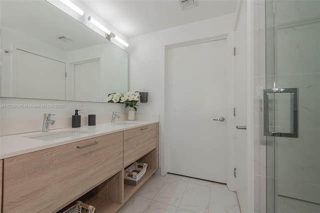 bathroom featuring marble finish floor, double vanity, a sink, and visible vents