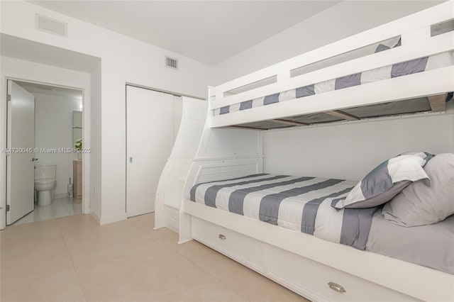 bedroom with visible vents, a closet, and light tile patterned flooring