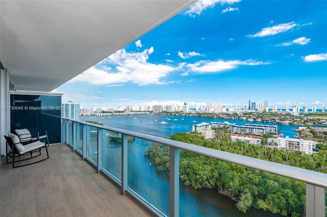 balcony with a water view and a city view