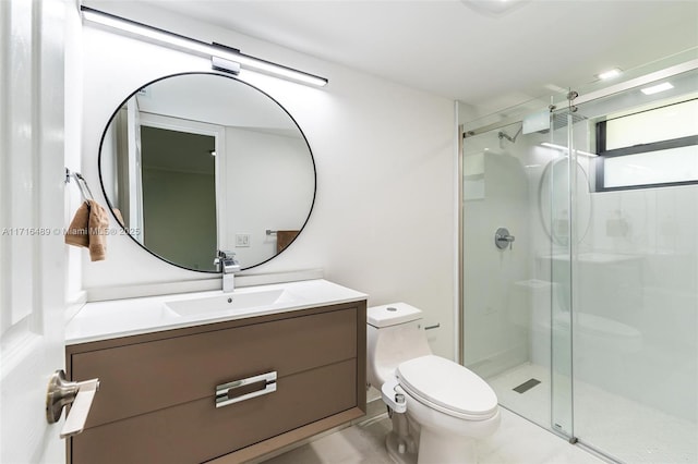 bathroom featuring vanity, a shower stall, and toilet