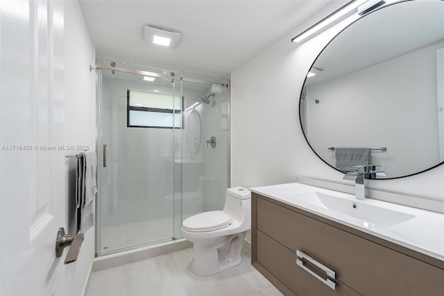 bathroom featuring toilet, a shower stall, and vanity