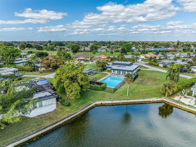 drone / aerial view with a water view and a residential view