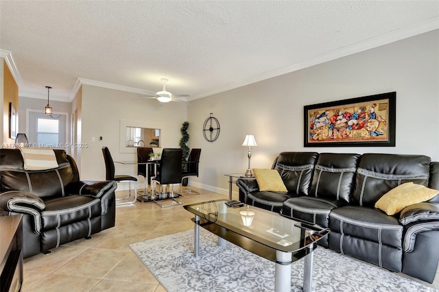 living room featuring ceiling fan, ornamental molding, a textured ceiling, and light tile patterned floors