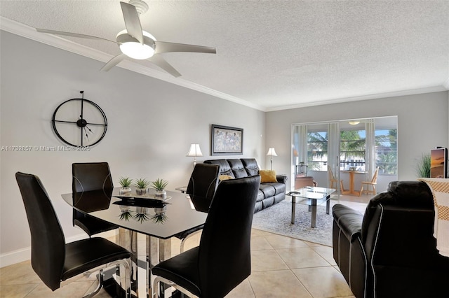 dining room with ceiling fan, ornamental molding, a textured ceiling, and light tile patterned floors