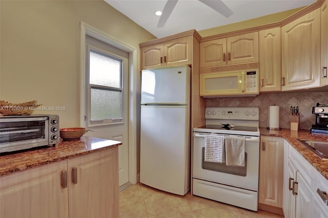 kitchen featuring ceiling fan, light stone counters, white appliances, and light tile patterned floors