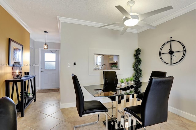 tiled dining room featuring crown molding, ceiling fan, and a textured ceiling